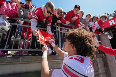 Ohio State Buckeyes cornerback Miles Lockhart (13) signs an autograph for a fan after the Ohio State Spring Game at Ohio Stadium in Columbus, Ohio on April 13, 2024.