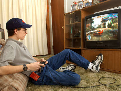 An 18 year old boy plays the video game Grand Theft Auto: Vice City at his home in 2003.