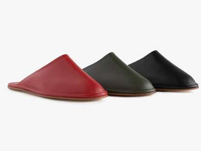 Three leather travel slippers, in red, olive green, and black.
