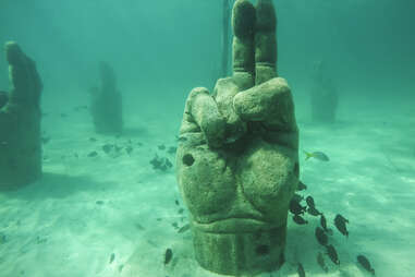 Stone hand is set underwater to attract fish while snorkeling off coast, Cancun, Yucatan Peninsula, Mexico