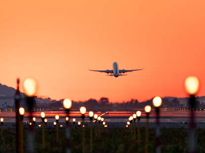 Airplane taking off at sunrise, travel and tourism.