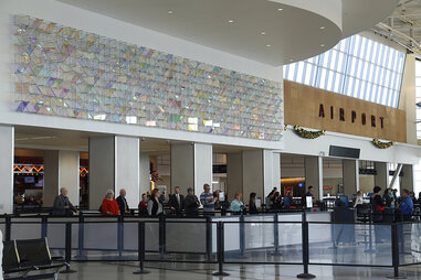 “Cloud Room Field” art installation above the security checkpoint at Hobby Airport by Christian Eckart. It is a large and shiny art installation.