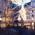 a lit-up street christmas market, or chriskindlmarkt, in Vienna 