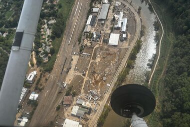 An aerial view of destroyed buildings and mud.