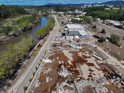 An aerial view of flood damage along the French Broad River in the aftermath of Hurricane Helene on October 2, 2024 in Asheville, North Carolina.