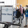 A sign guides volunteers to the Global Entry automatic kiosks.