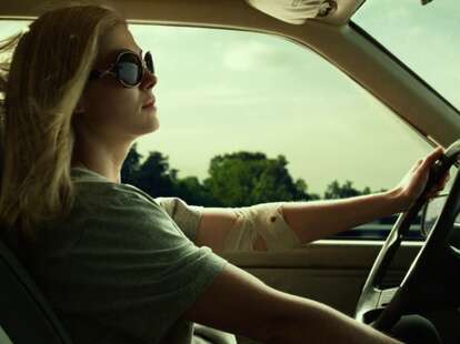 Rosamund Pike as Amy Dunne driving in the 2014 film Gone Girl.