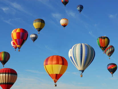 hot air balloons floating up in the sky in Albuquerque