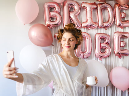Young bride begins preparations for bachelorette celebration with balloons.