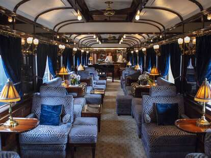 a blue plush interior of a luxury train