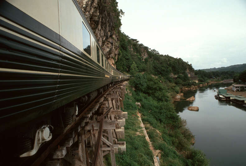 train rounding a bend on a bridge