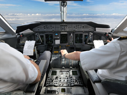Pilots in the cockpit of an airplane.