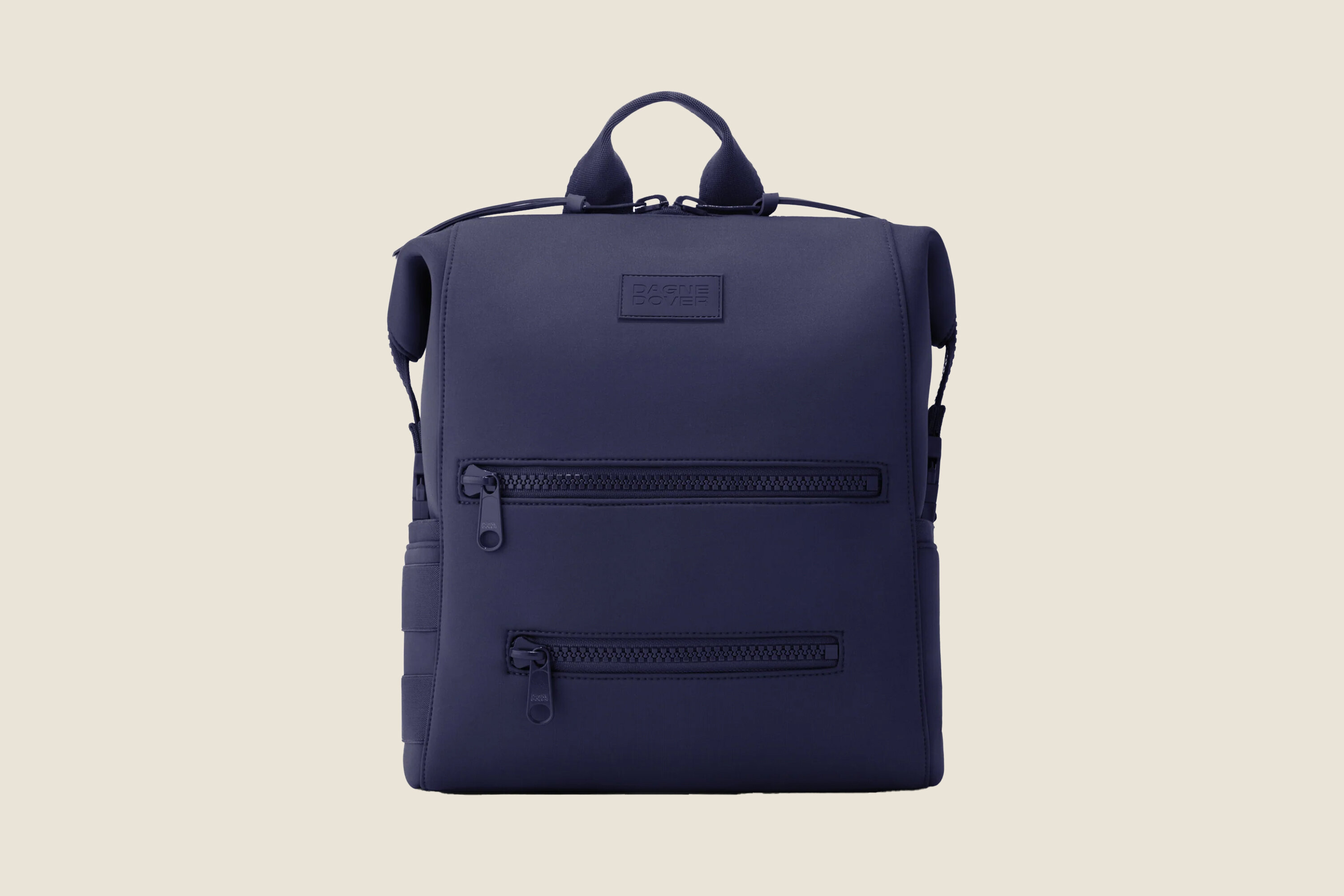 A dark blue neoprene Dagne Dover diaper bag backpack.