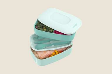 A turqouise bento box, opened to show contents.