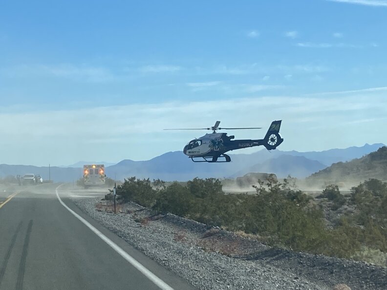 A helicopter ambulance landing in Death Valley during an emergency.