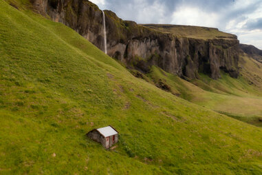 tiny elf house in rolling green hills of iceland