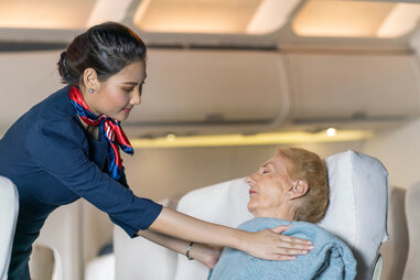 flight attendant assisting in medical emergency