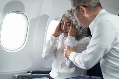 sick woman on airplane