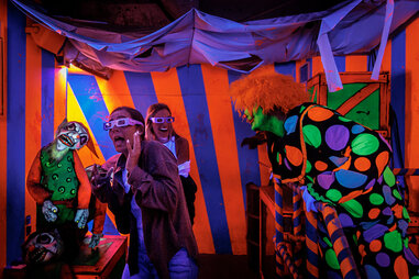 a blacklight room in a haunted house with clowns