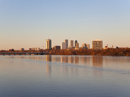 The downtown Tulsa Skyline from across the Arkansas River at sunset.