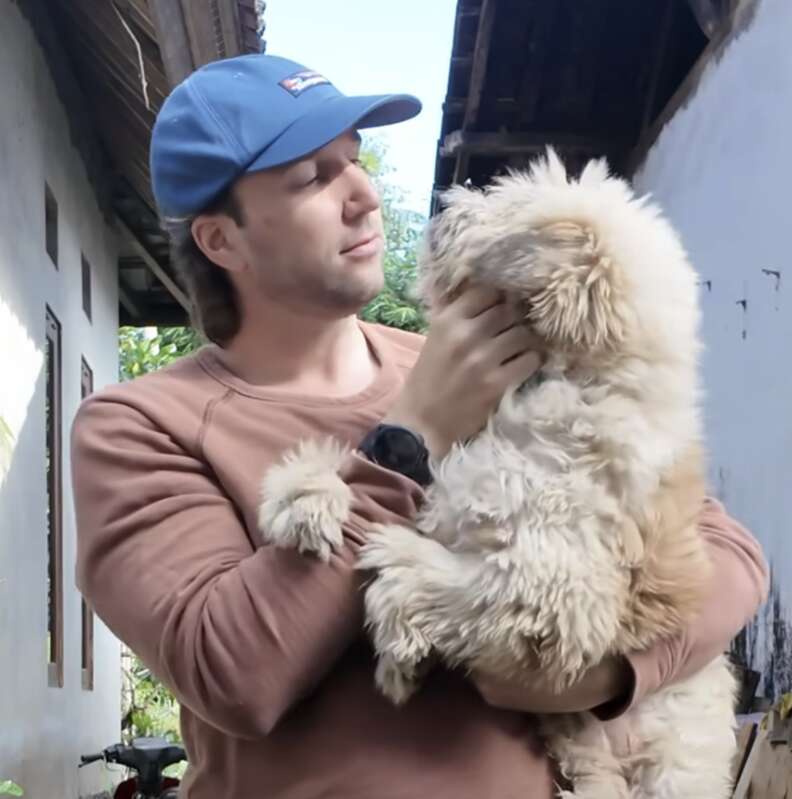 man holding dog 