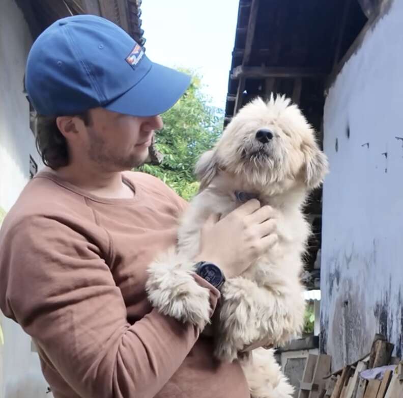 man holding dog 