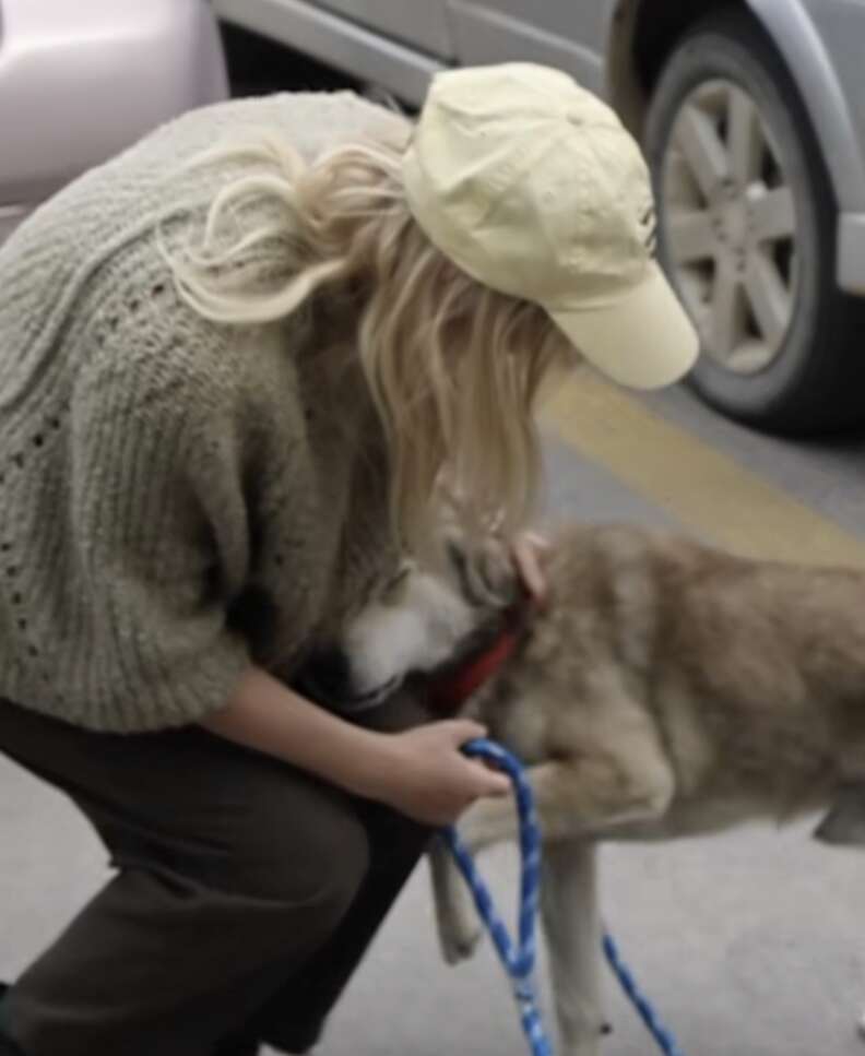 woman and dog hugging