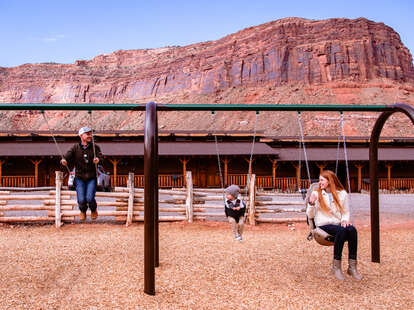 family on a swing at red cliffs lodge near moab, utah