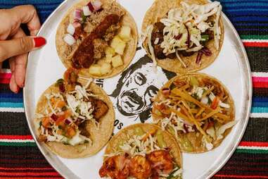 five tacos on a plate from trejo's tacos