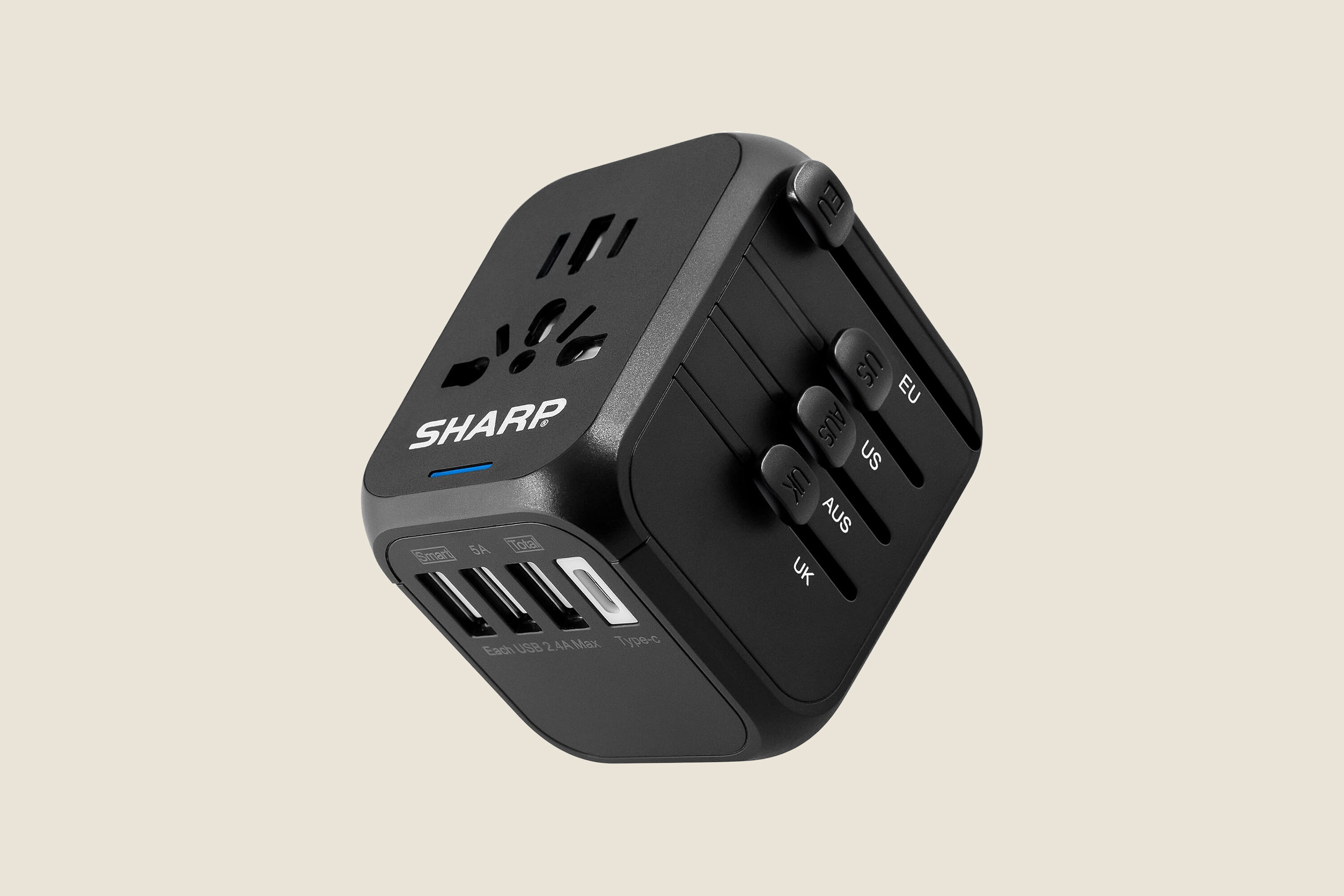A black, cube universal travel adapter.