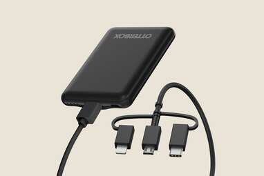 A black portable charger with cables.