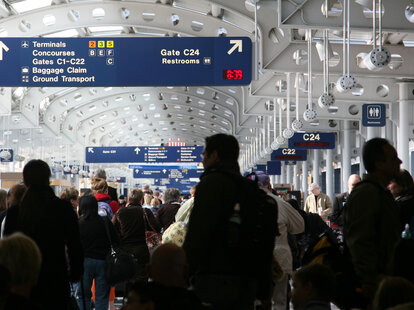 Passengers walking through airport concourse in O’Hare, Chicago, Illinois, USA.