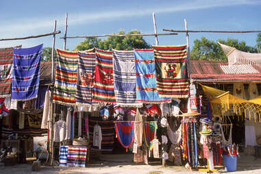 colorful blankets, hammocks, and hats for sale in downtown Tulum 