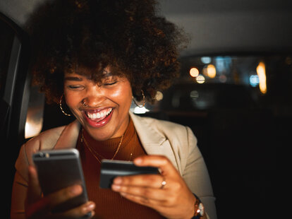 Woman with a smartphone and credit card.