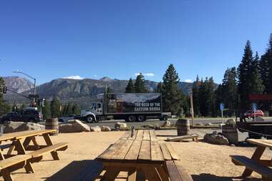 beer garden tables, beer truck, and the mountains at mammoth brewing in mammoth lakes