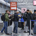 Travelers wait in a security checkpoiont line at O'Hare International Airport