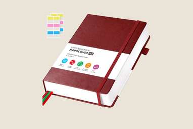 A red, thick leather bound journal.