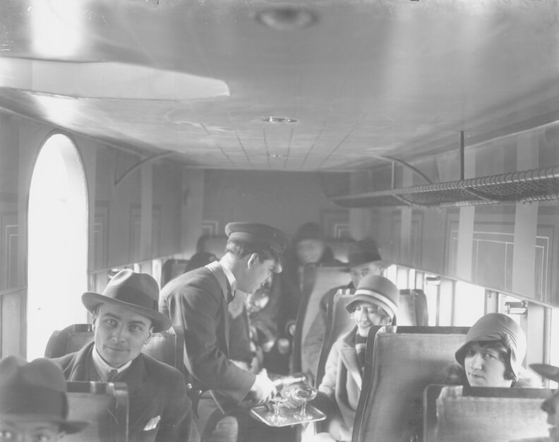 Champagne service on a commercial flight, ca. 1929