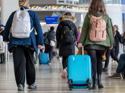 People enter LaGuardia Airport (LGA) on one of the busiest travel days of the year