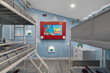 a toy story themed room including bunk beds and an etch a sketch at an airbnb near disneyland
