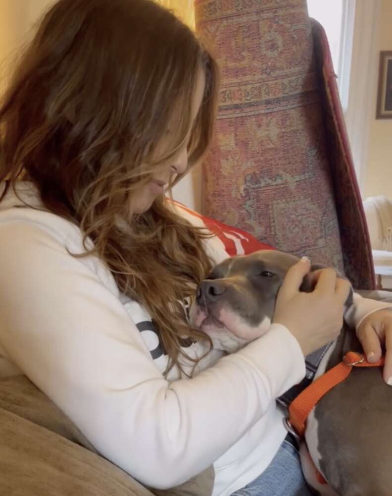dog cuddling with woman