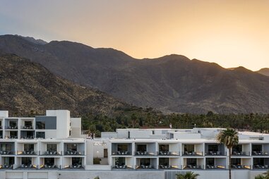 Thompson Palm Springs hotel in front of the mountains at sunset in the coachella valley