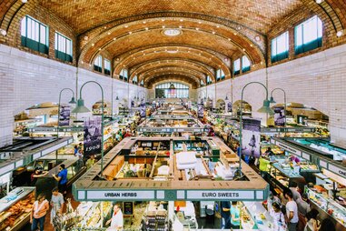 high arching ceiling above west side market with signs for spices and produce in cleveland, ohio