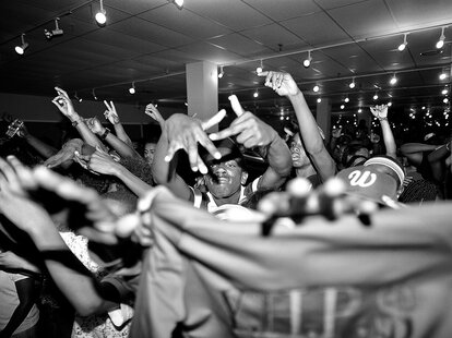 A black and white film photo of a rowdy concert in Washington, DC.