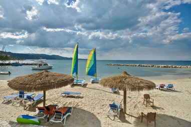 A couple jumps into the ocean from a bridge in Montego Bay, Jamaica.