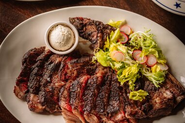 tomahawk steak on a plate at the charles in dallas, texas