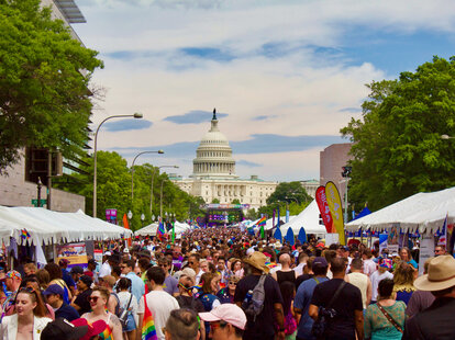 A crowd of people celebrates Pride in front of the Capitol building in Washington, D.C..