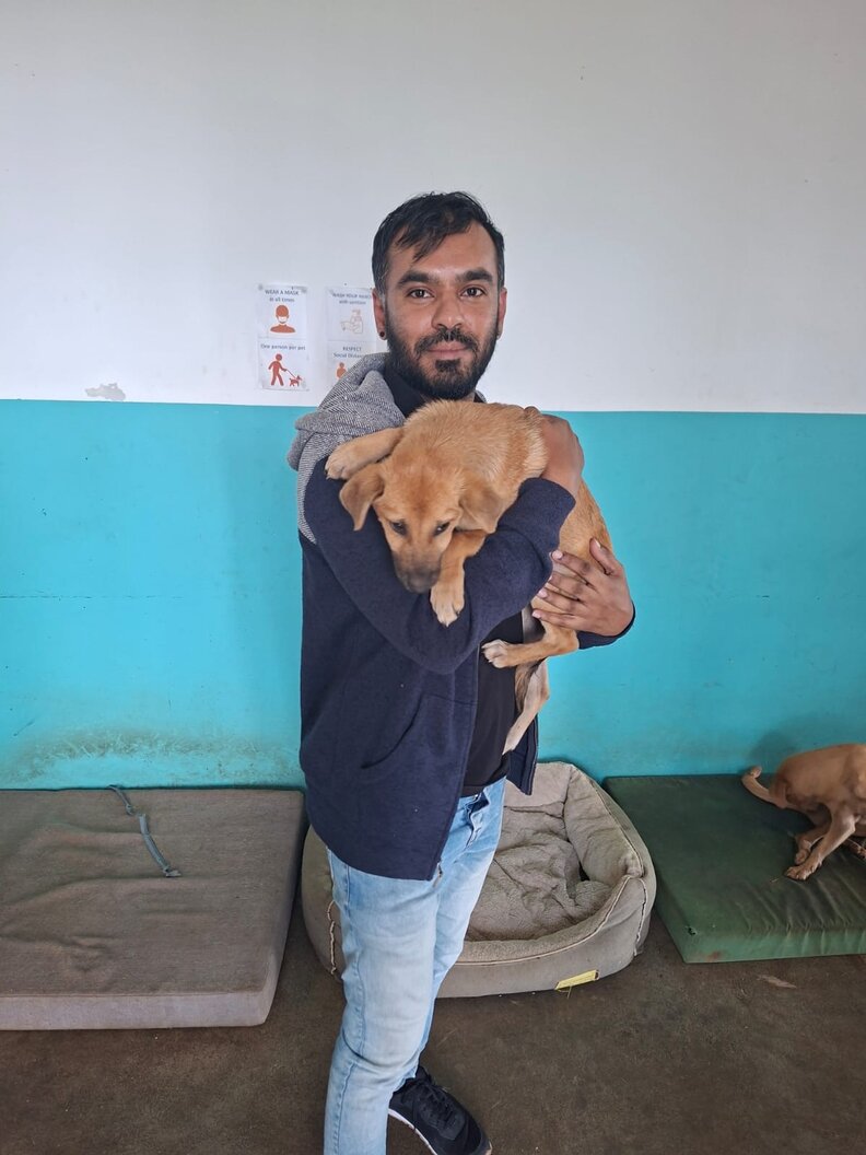 man holding dog 