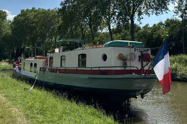 a barge docked on the grassy edge of a canal in Burgundy, France