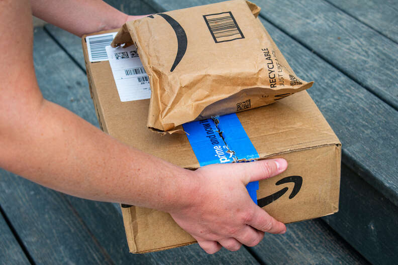 Amazon delivery driver approaching porch with cats nearby